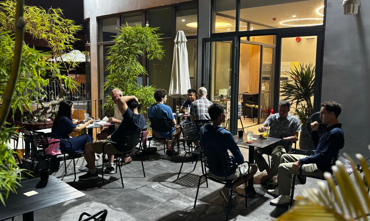 A wide view of numbered small conversation tables during the Friday, April 24, 2026 Da Nang Language Exchange session.