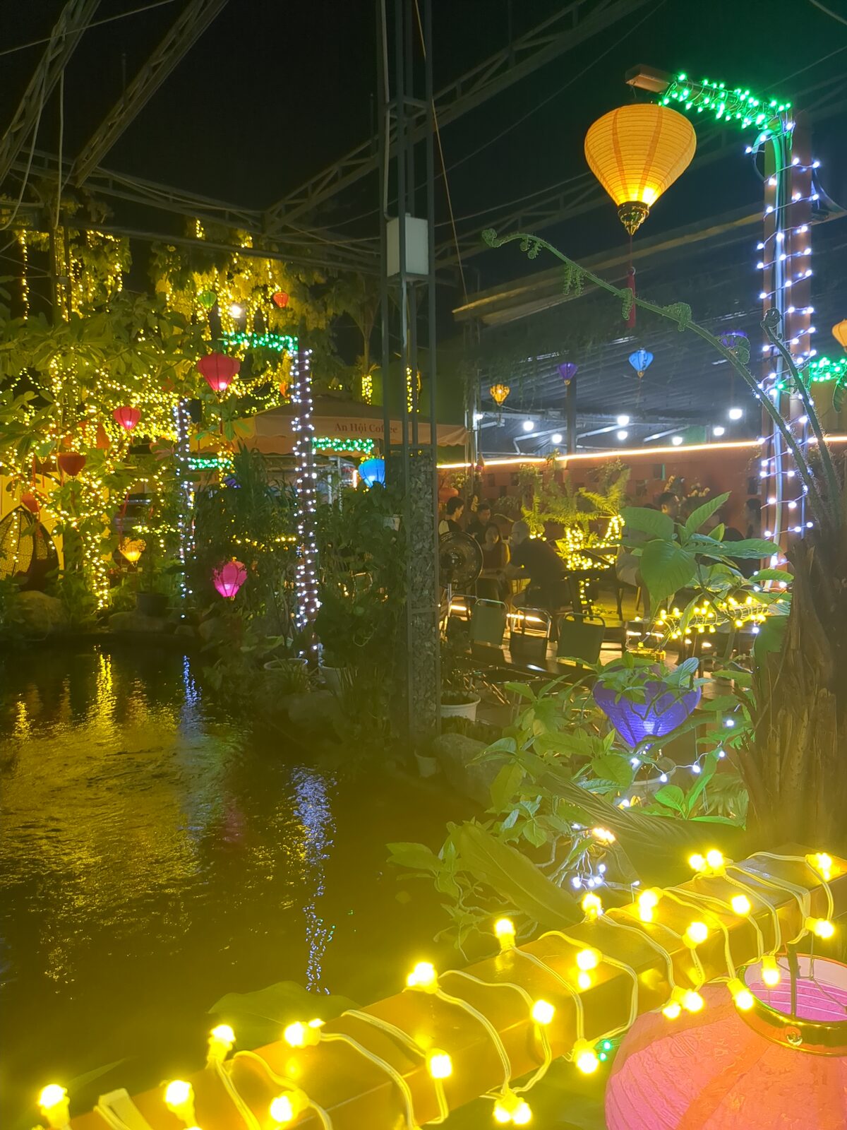 Lanterns, water, and outdoor seating at the Friday, April 3, 2026 language exchange session at An Hoi Cafe.