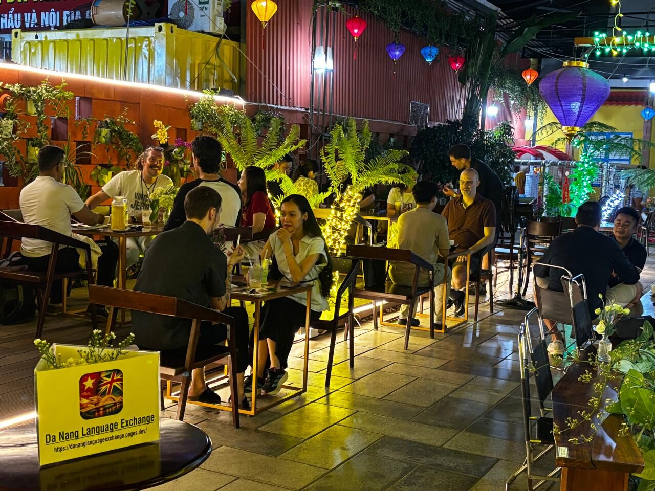 Small conversation tables during the Friday, April 3, 2026 Da Nang Language Exchange session at An Hoi Cafe.